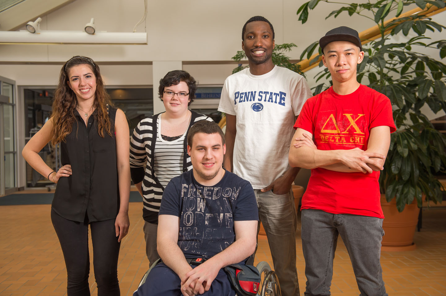 Group of five Penn State Behrend students of diverse backgrounds in wintergarden
