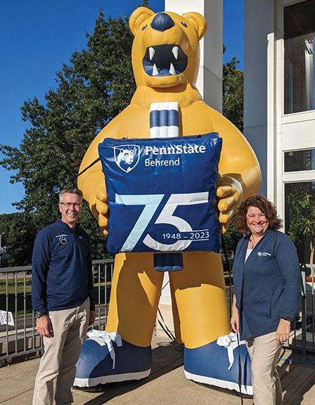 Chancellor Ralph Ford and Melanie Ford with the inflatable lion