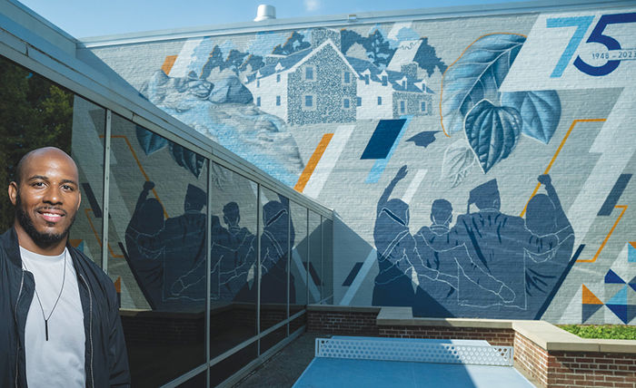 “Behrend Pride,” a temporary mural painted by Erie artist Ceasar Westbrook, features depictions of Glenhill Farmhouse, Wintergreen Gorge, and the silhouettes of four graduates standing arm-in-arm at commencement.